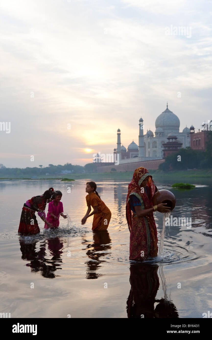 Taj Mahal & collecting water on the banks of the River Yamuna, Agra, India Stock Photo