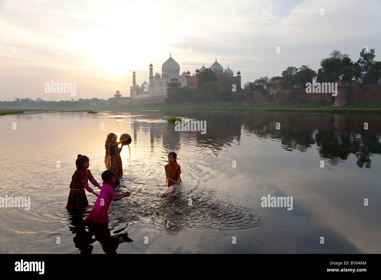 Taj Mahal & collecting water on the banks of the River Yamuna, Agra, India Stock Photo