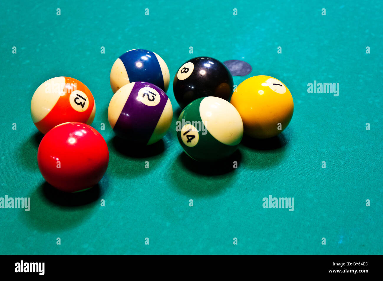 cluster of colored balls on billiard table Stock Photo
