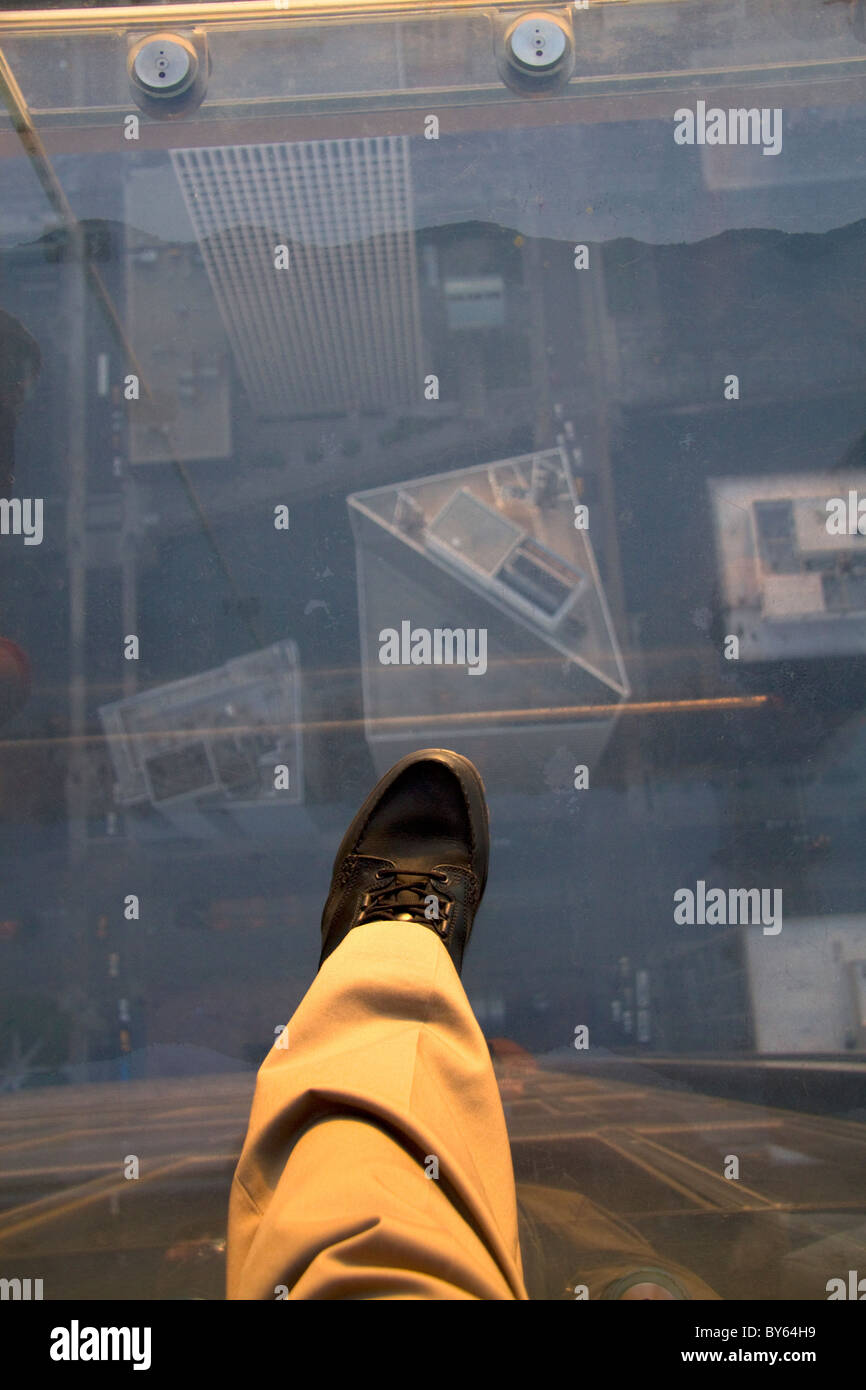 A man's foot on the skydeck of the Willis Tower in Chicago, Illinois, USA. Stock Photo