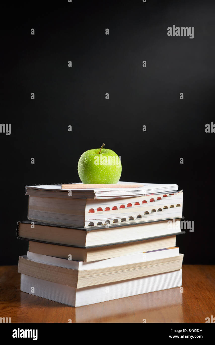 Green apple over pile of books for shool concept Stock Photo