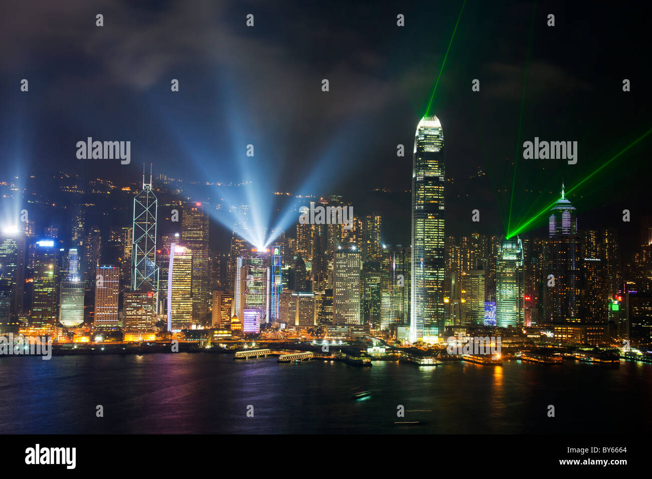 The amazing hong kong symphony of lights laser show over victoria harbour  from kowloon. Neon lights and lasers cut the night sky Stock Photo - Alamy