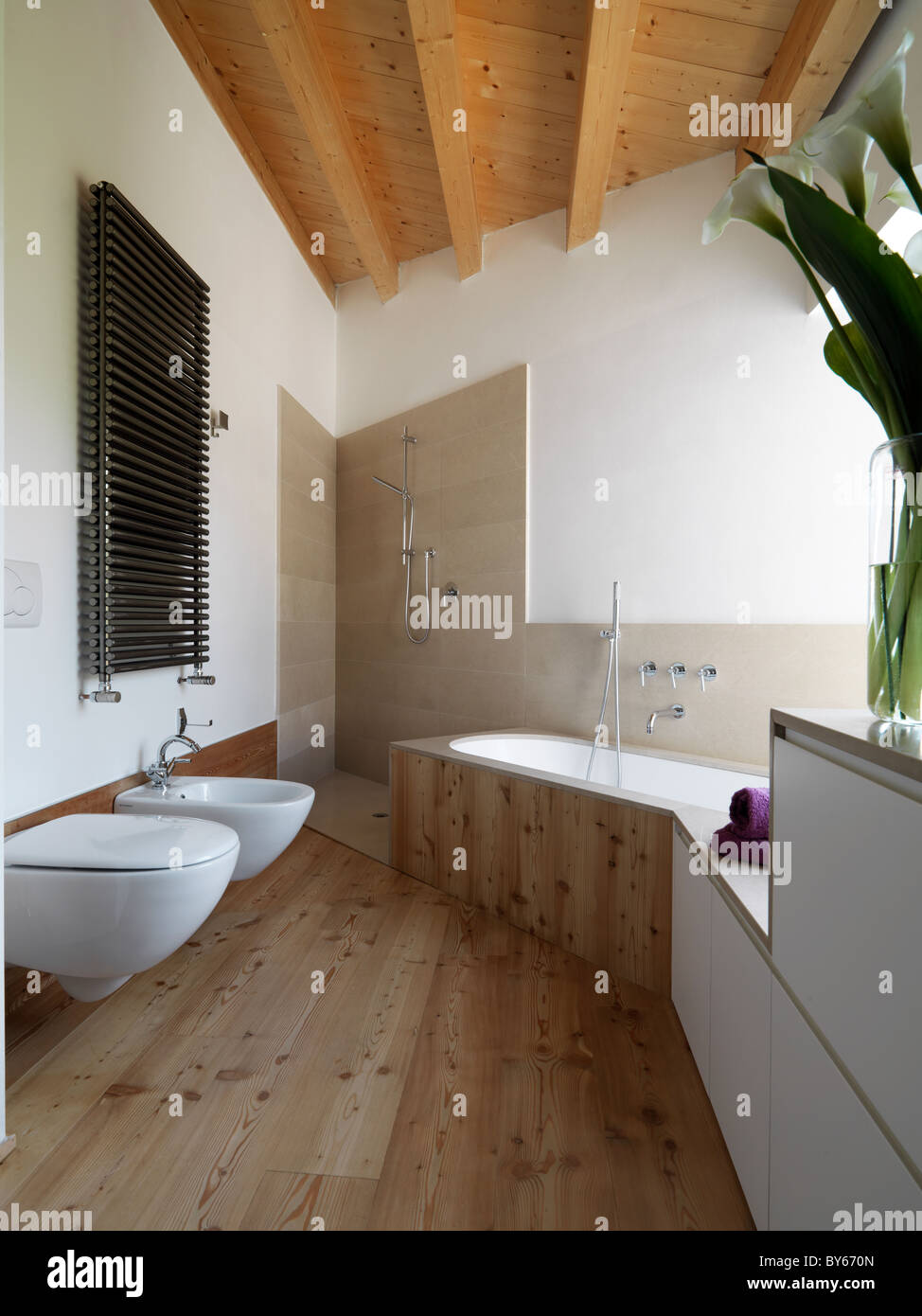 modern bathroom with a wooden floor and bathtub Stock Photo