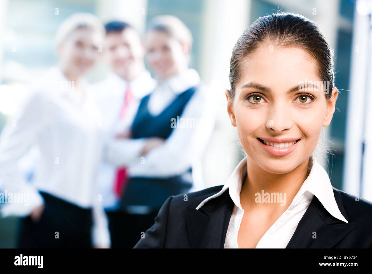 Face of female leader on the background of her business team Stock ...