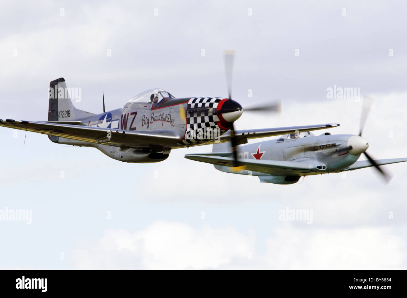 North American P-51D Mustang 'Big Beautiful Doll' and Yakovlev Yak-3UA in a formation flypast at Duxford Flying Legends Airshow Stock Photo