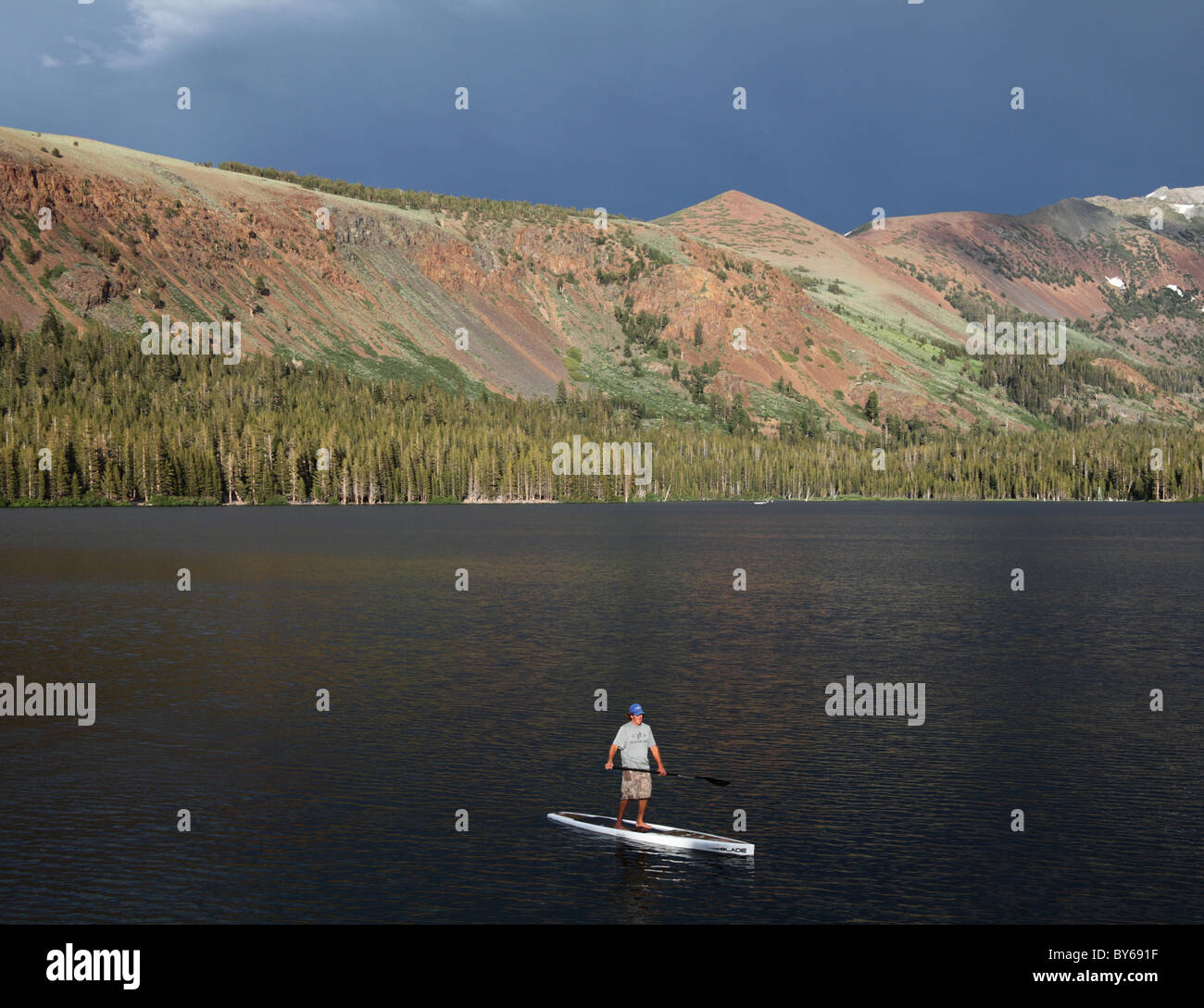 Stand up paddleboarder explores Lake Mary in the Mammoth Lakes Basin Stock Photo