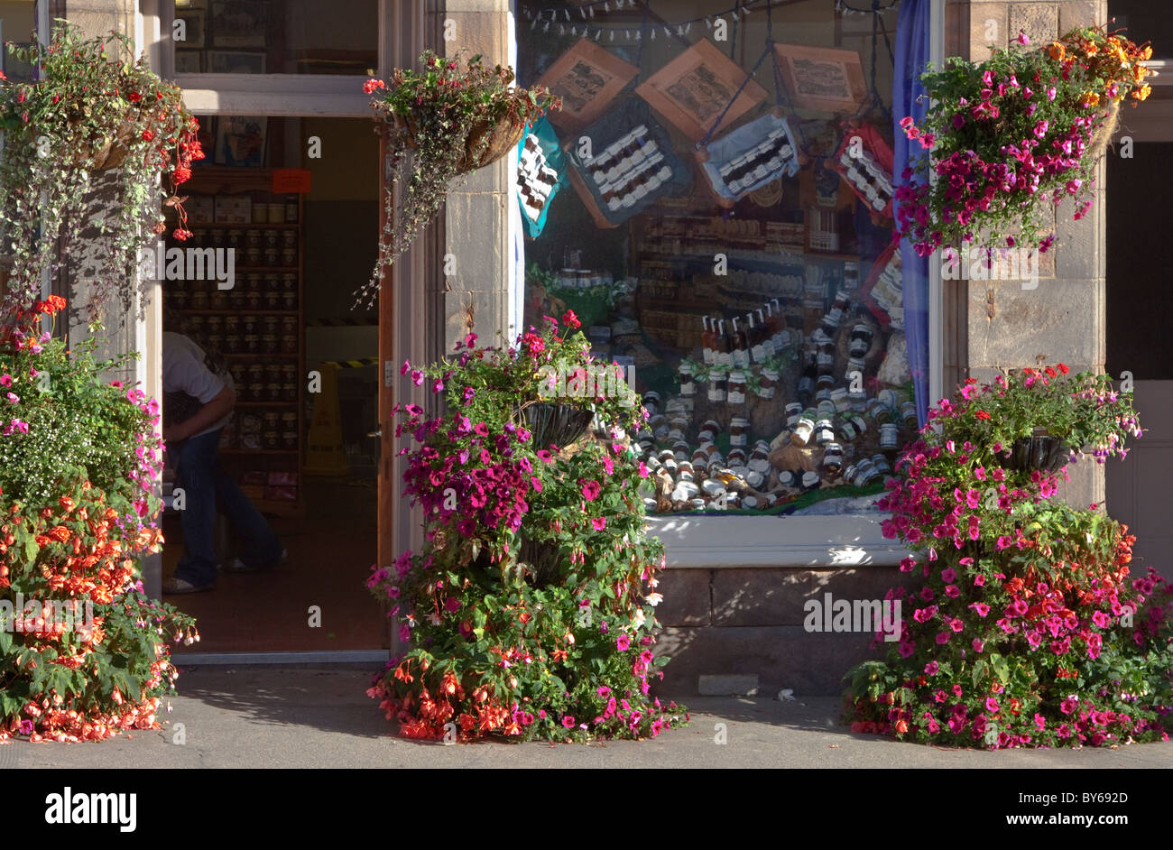 Shop front with hanging baskets in the town of Crail, Fife, Scotland Stock Photo Alamy