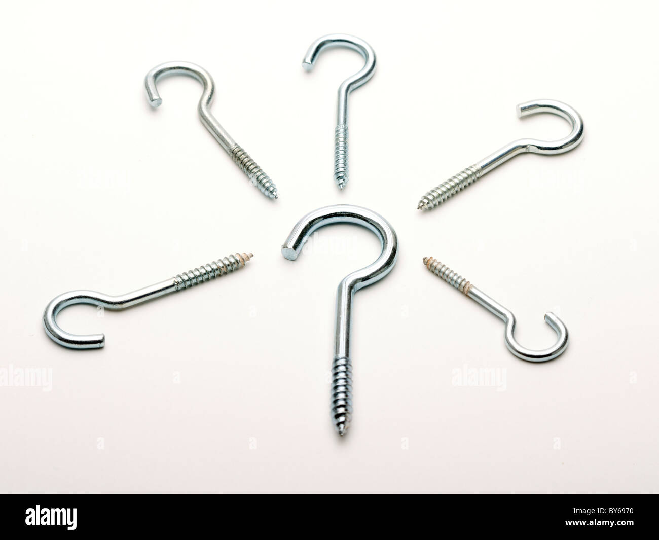Metal screw in hooks arranged on a white background Stock Photo Alamy