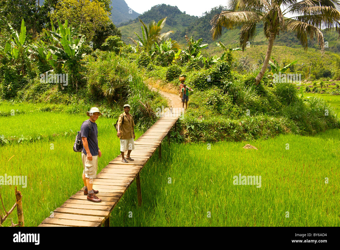 Tourist and park guide walking to the entrance to Marojejy National Park in northeast Madagascar. Stock Photo