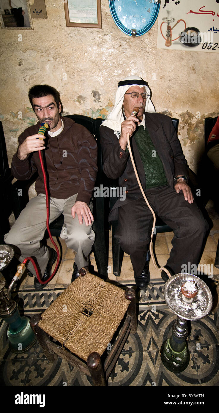 Palestinian men smoking Nargilas at a tea house in the old city of Jerusalem. Stock Photo