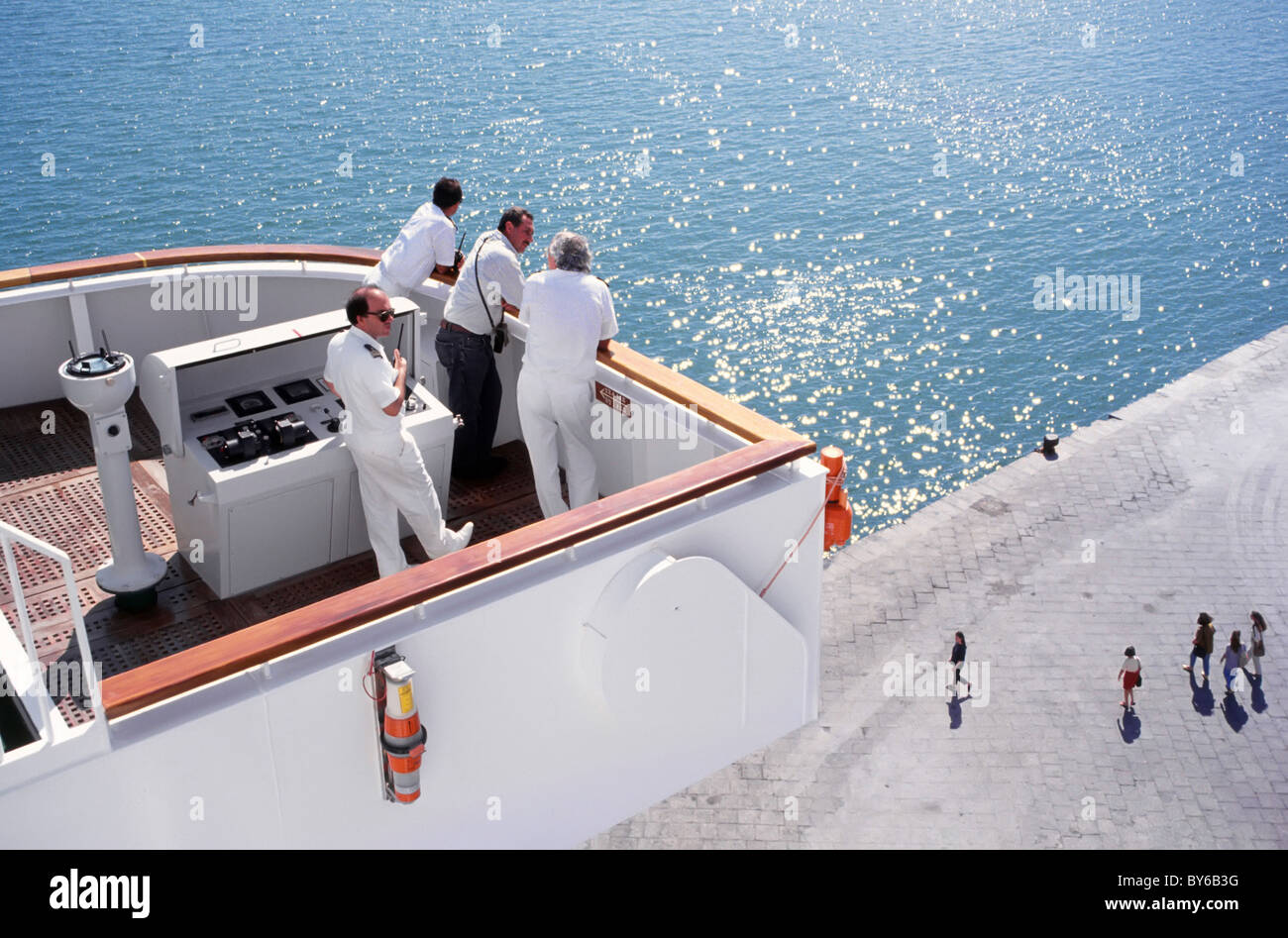 Cruise ship liner captain and officers on wing bridge with local port