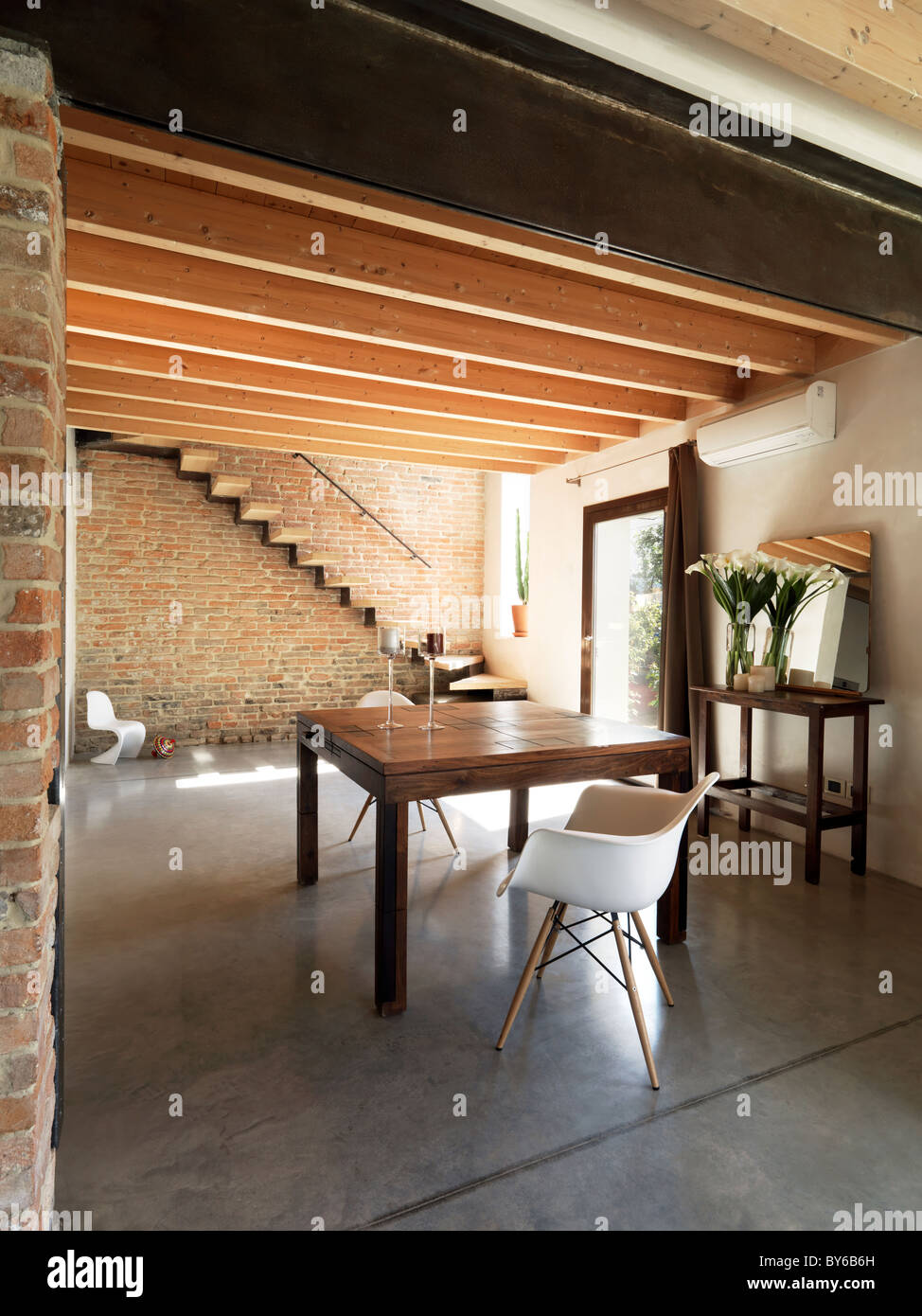 old table with armchair on dining room near at the staircase and main