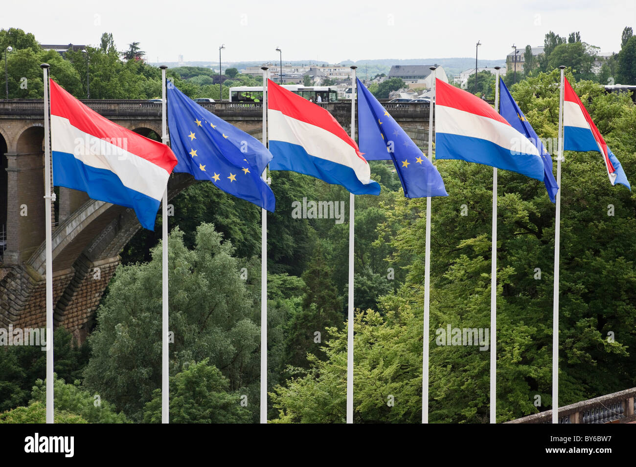 Boulevard Roosevelt, Luxembourg, Europe. Grand Duchy and EU flags with Adolphe bridge across the Pétrusse valley Stock Photo