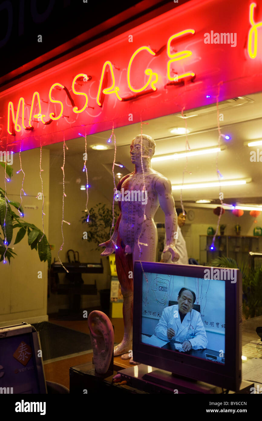 Doctor on TV screen at a traditional Chinese herbalist's shop window in London's West End. Stock Photo