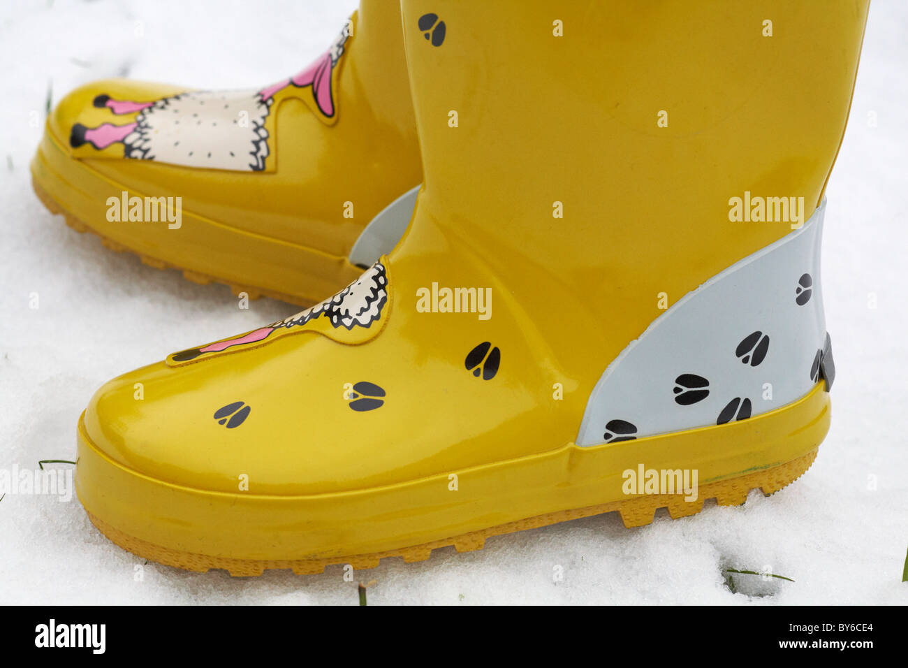 Yellow wellies in the snow Stock Photo - Alamy