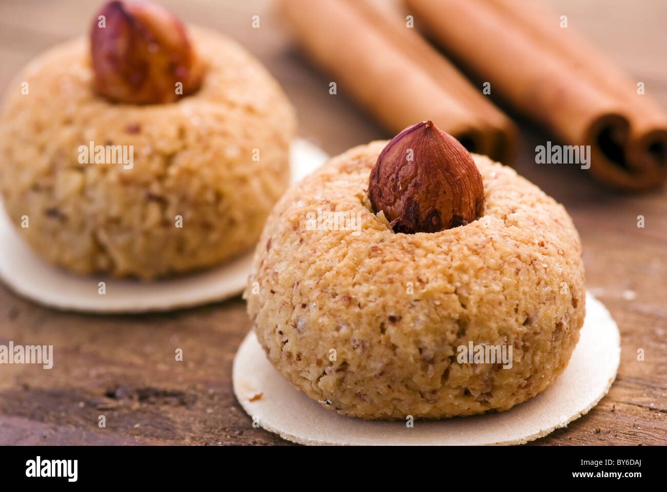 Christmas cookie with cinnamon stick as closeup on wood Stock Photo