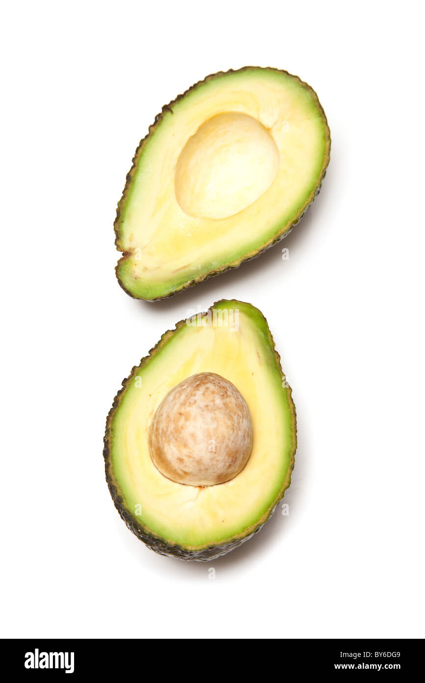 Avocado pear halved and isolated on a white studio background Stock