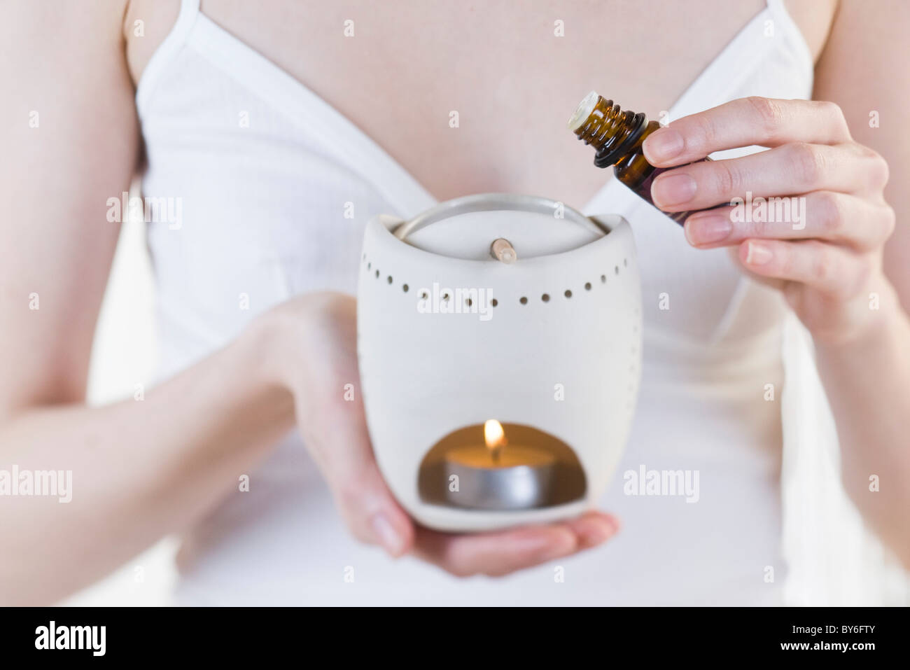 Woman using aromatherapny burner Stock Photo