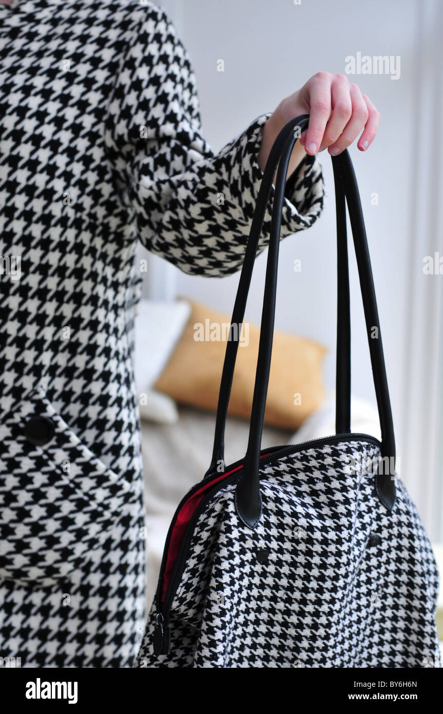 Dogstooth houndstooth coat and bag Stock Photo