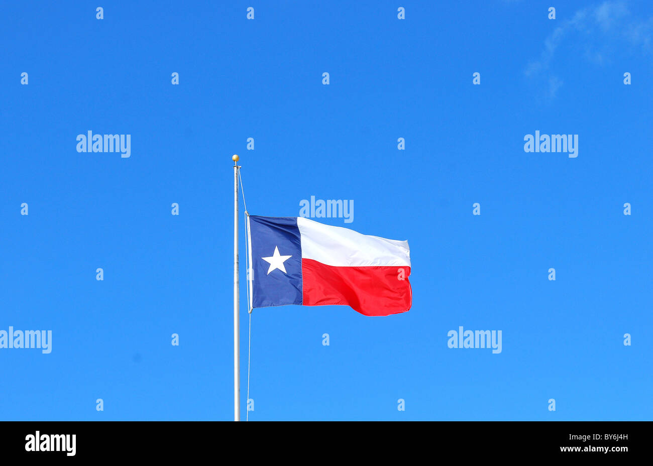 Texas flag flying high in the skies. Stock Photo