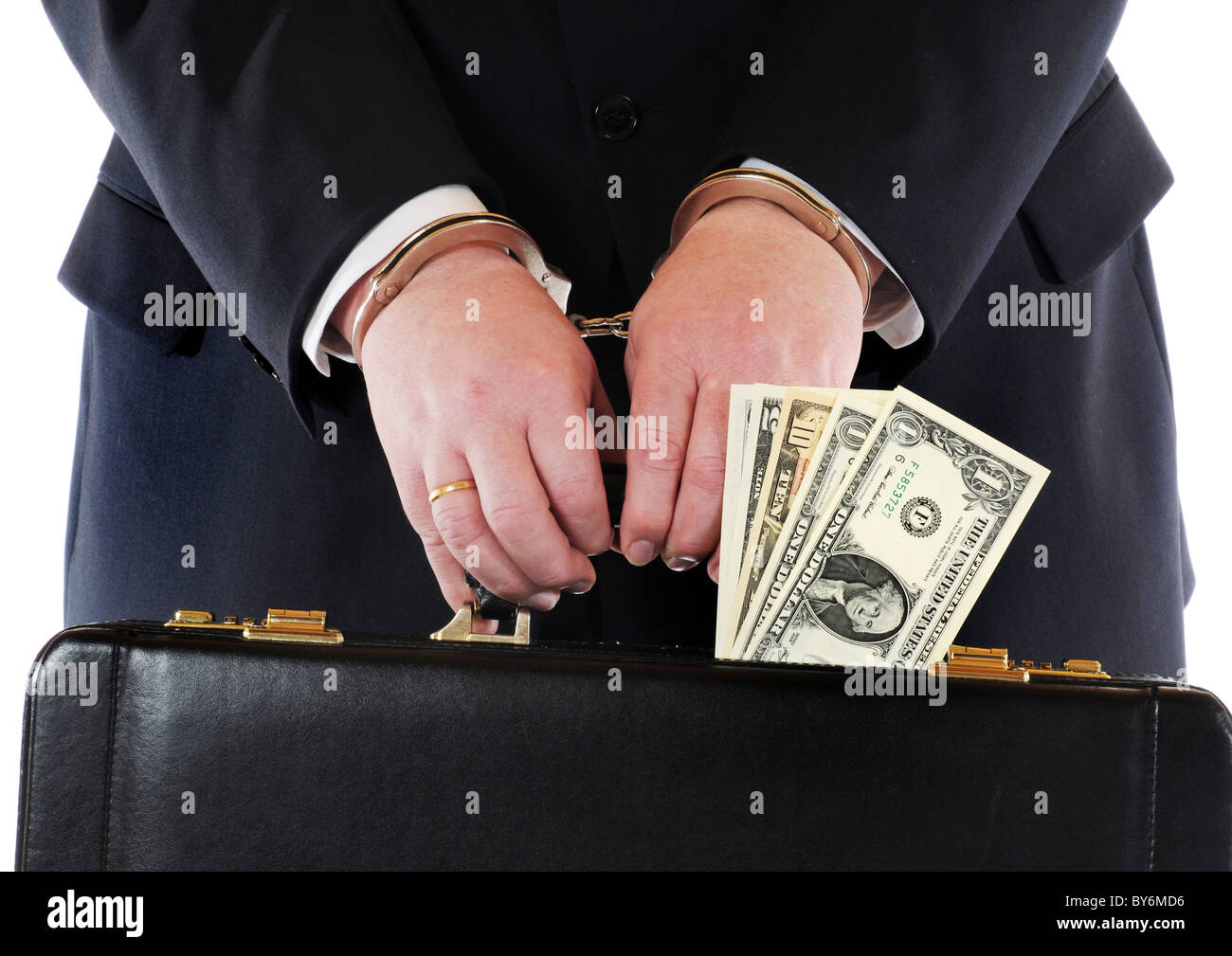 Hands of a man with suitcase in handcuffs Stock Photo