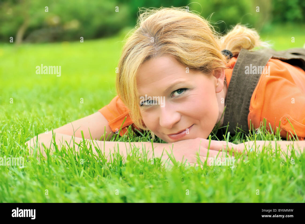 Young woman relaxing on grass Stock Photo - Alamy