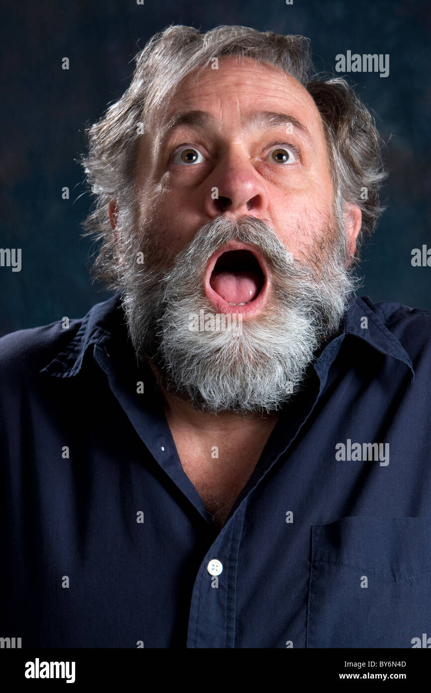 Mature man frightened by something he saw. Stock Photo