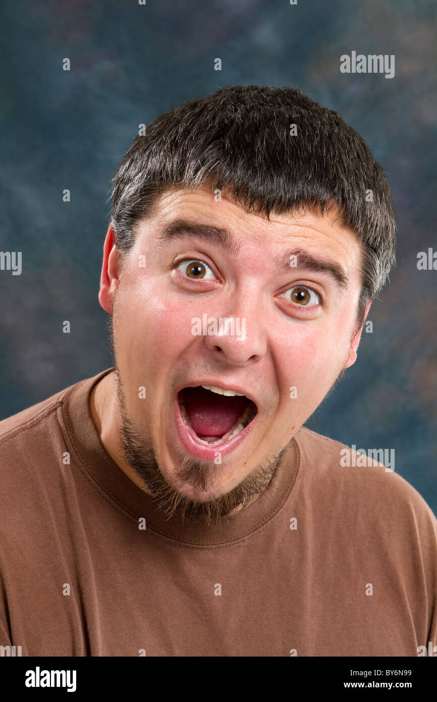 Man shows his surprise and gleefulness with the expression on his face. Stock Photo