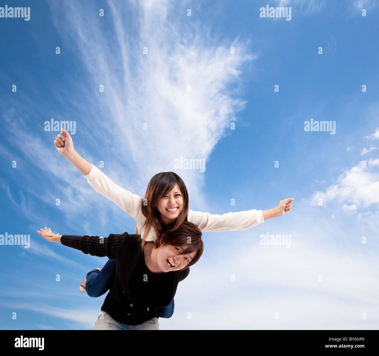Young Asian Couple smiling under blue sky and cloud Stock Photo - Alamy