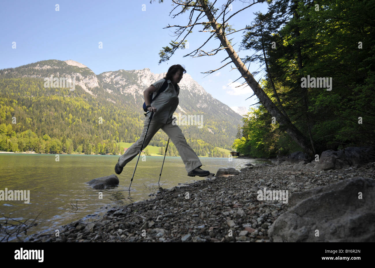 Hiker on the shore of lake Hintersteiner near Scheffau at Wilder Kaiser, Tyrol, Austria Stock Photo