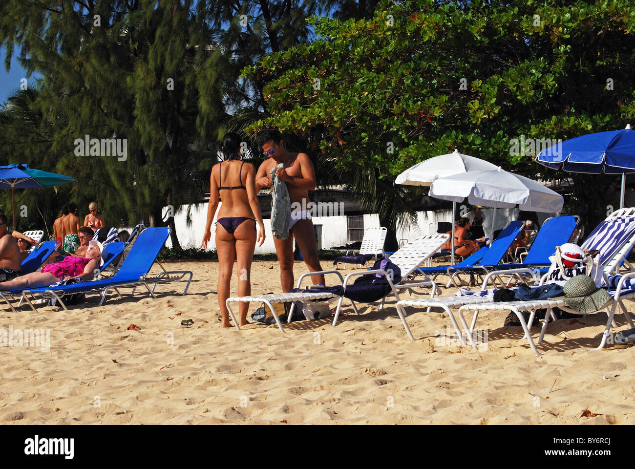 Holidaymakers on beach, Bridgetown, Barbados, Caribbean. Stock Photo