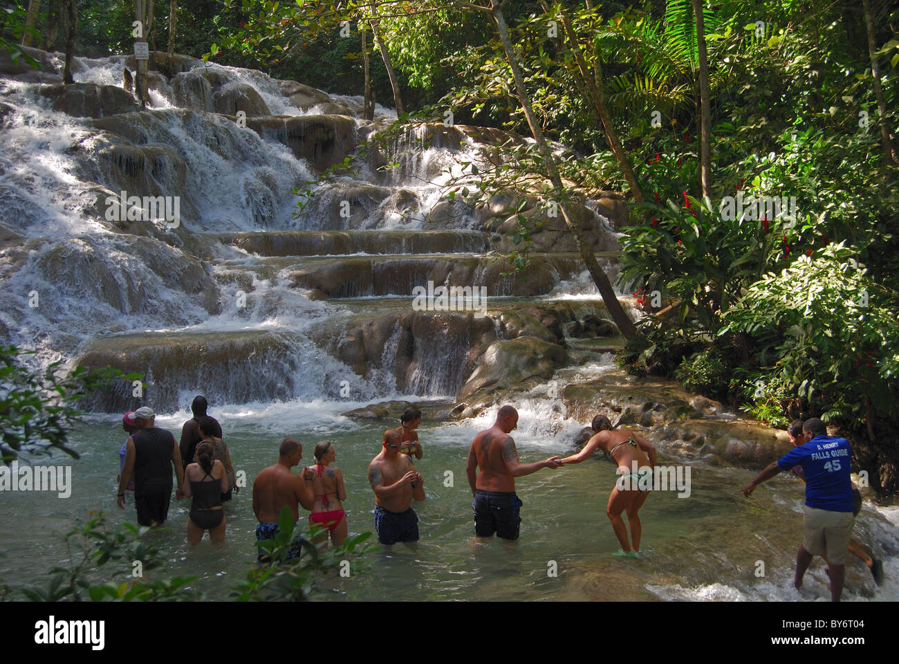 People standing in Dunns River Falls, Ocho Rios, Middlesex County, Jamaica, Caribbean. Stock Photo