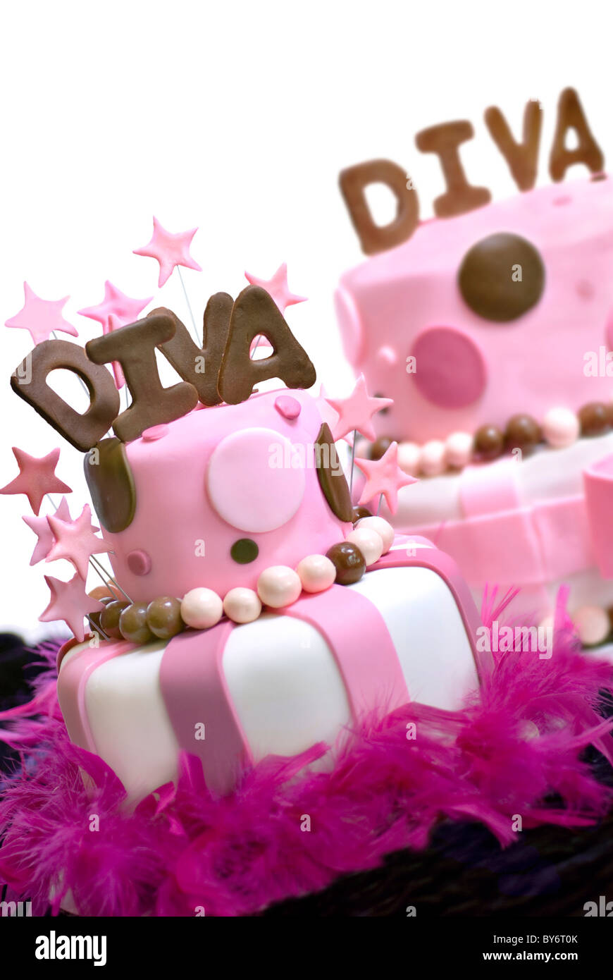 Two pink fondant cakes with Diva spelled out on top and stars garnishing the front cake. Front cake is in focus, rear cake out o Stock Photo