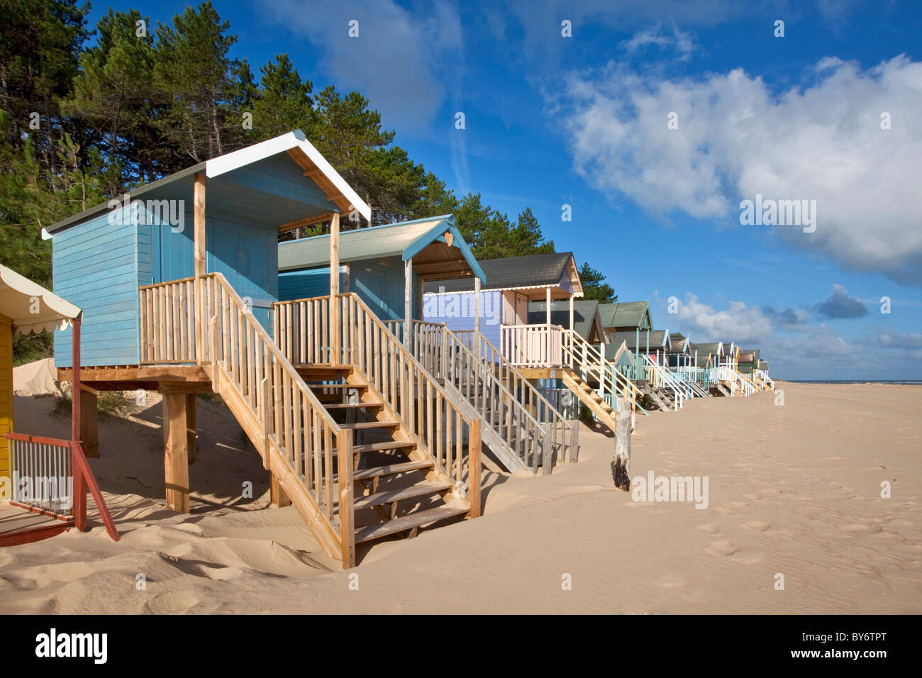 Colourful beach huts at Wells Next The Sea on the North Norfolk Coast on a summers morning Stock Colourful beach huts at Wells Next The Sea on the North Norfolk Coast on a summers morning Stock