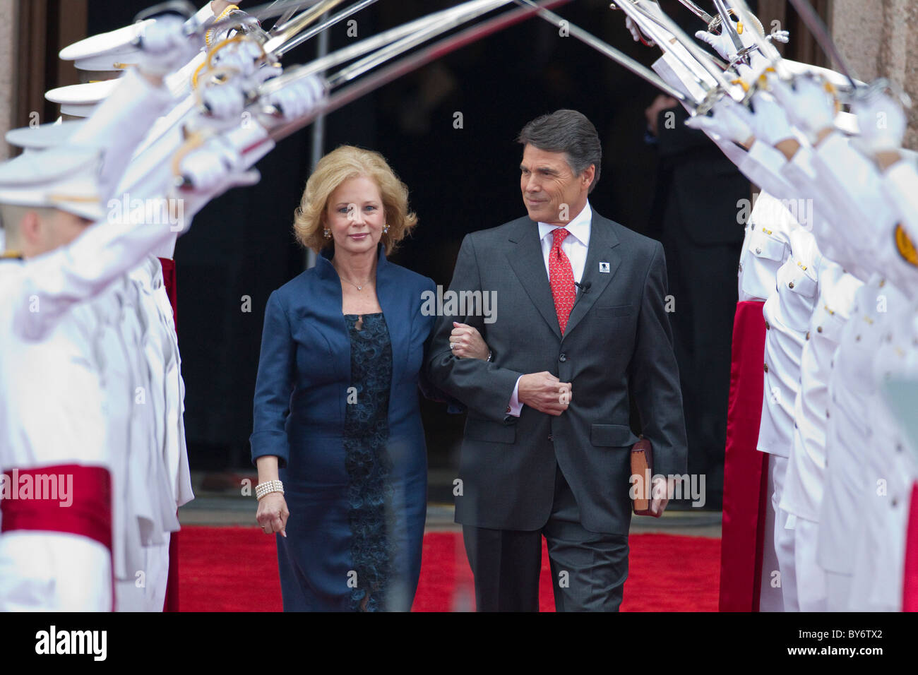Texas Gov. Rick Perry, wife Anita enter through an arch of swords before taking the oath of office after re-election in November Stock Photo