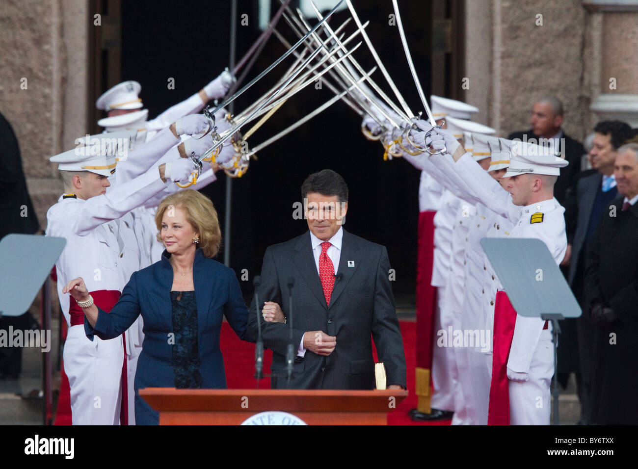 Texas Gov. Rick Perry, wife Anita enter through an arch of swords before taking the oath of office after re-election in November Stock Photo