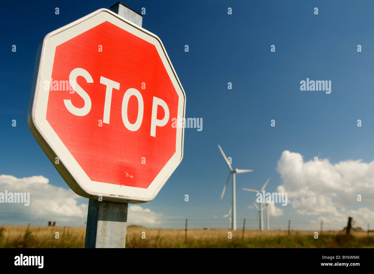 Stop sign and in the background the wind park at the Cap Fagnet (2006) north of Fecamp (France). Stock Photo