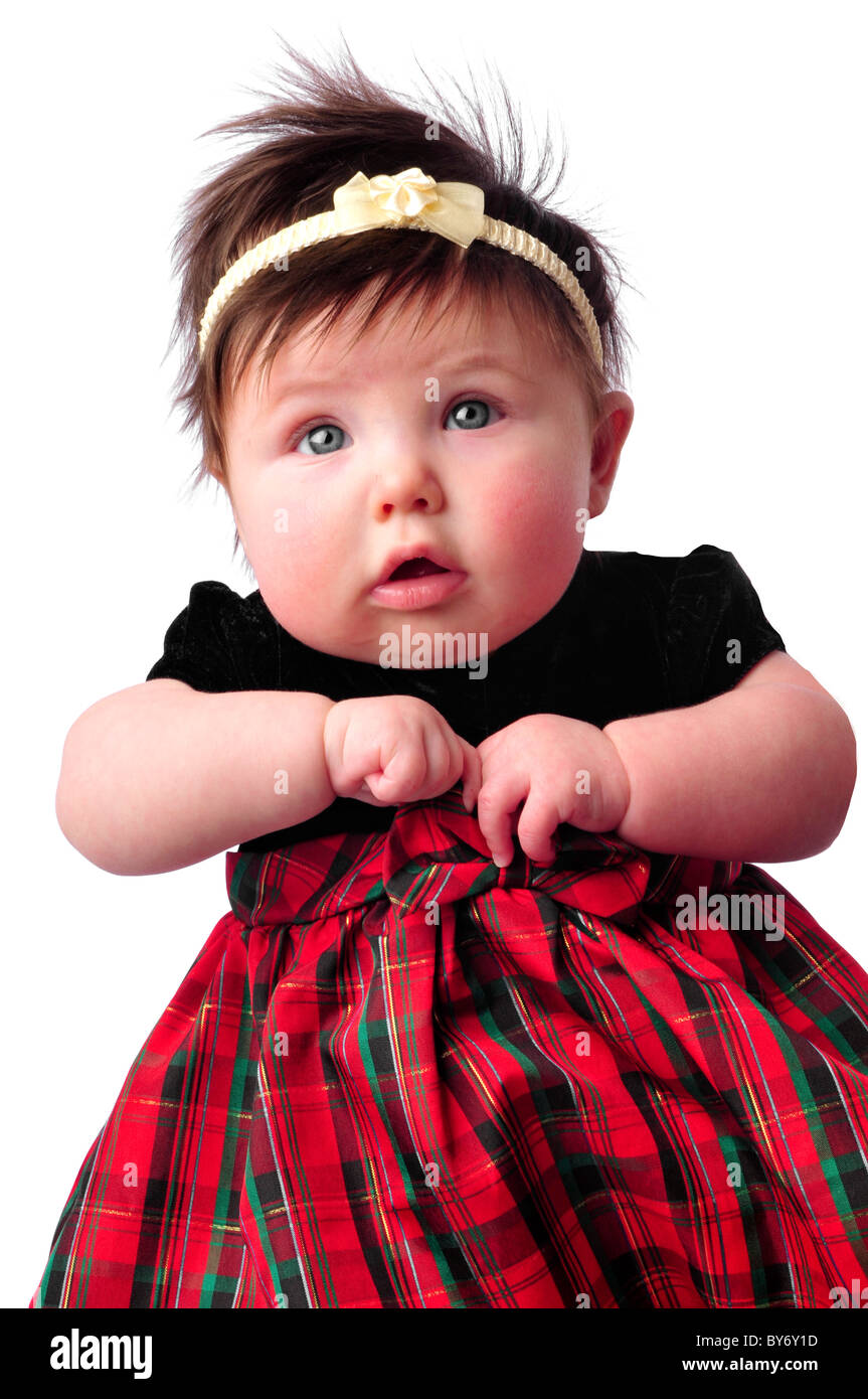 baby on white in checkered dress counting fingers Stock Photo