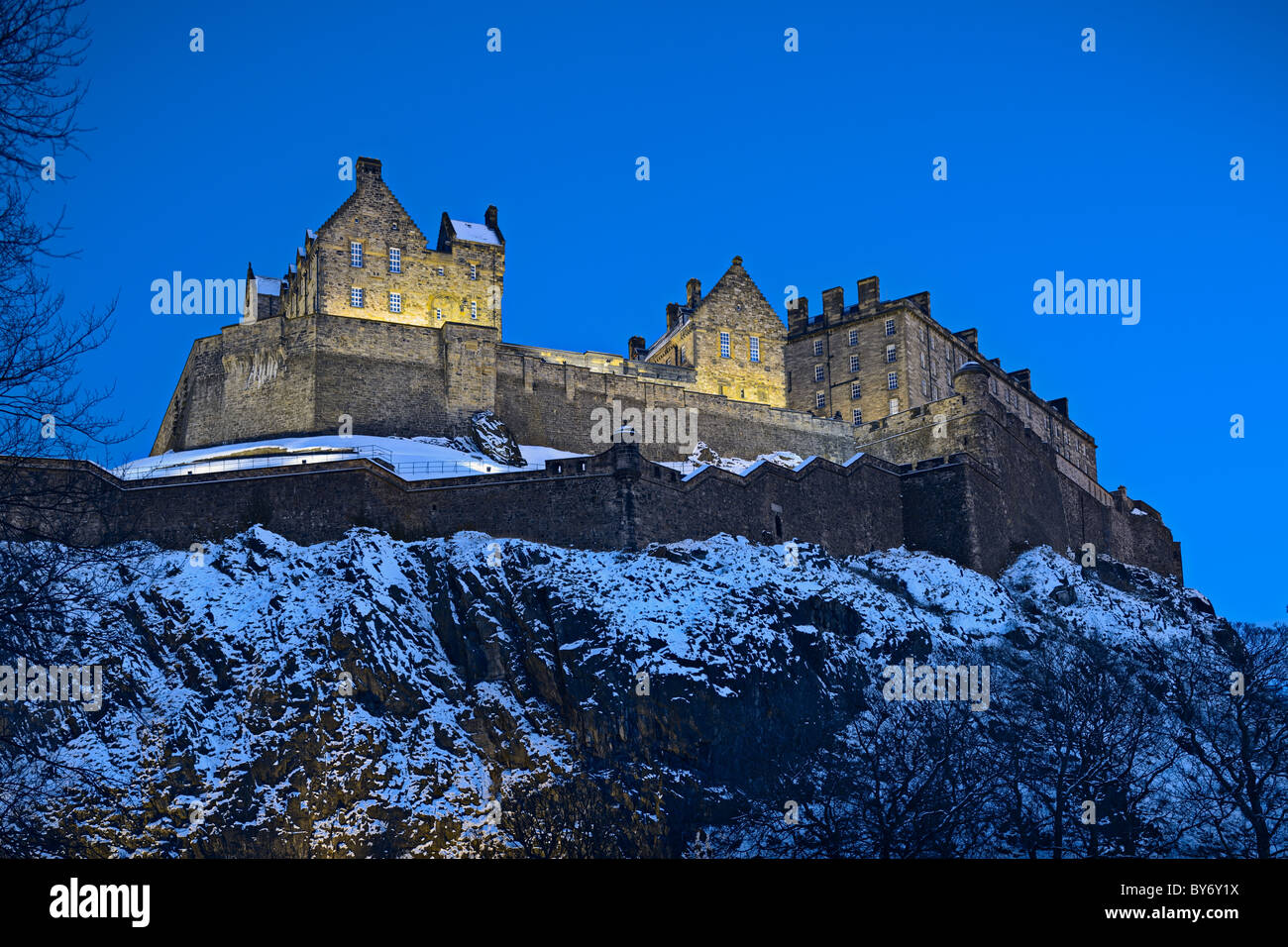 Edinburgh Castle, Scotland, UK, illuminated at dusk with winter snow Stock Photo