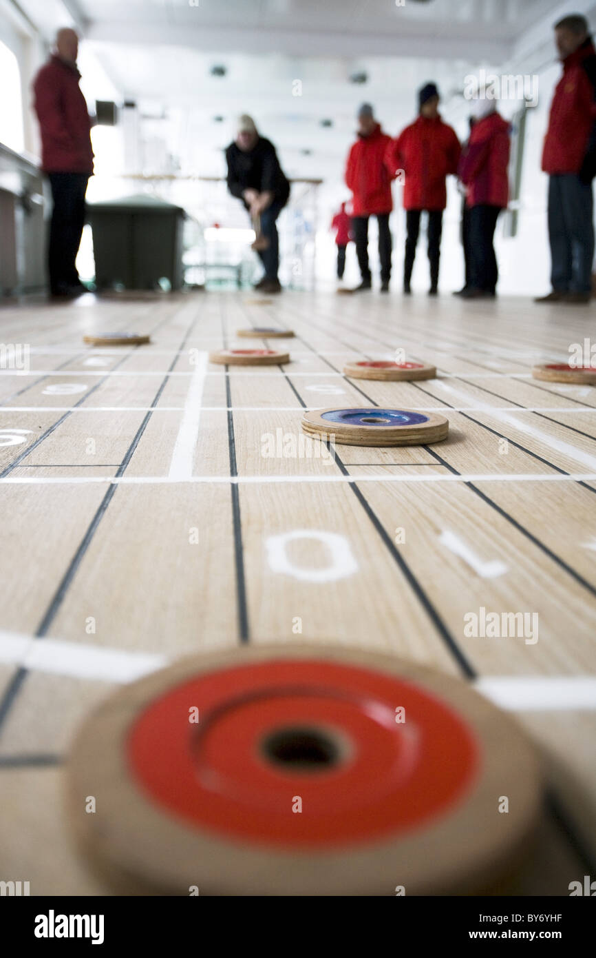 Passengers play shuffleboard aboard cruiseship MS Deutschland (Deilmann