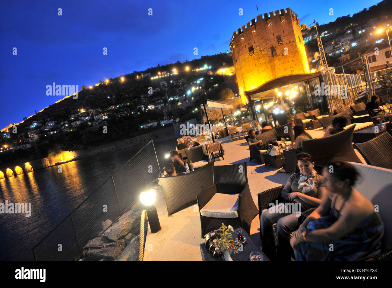 Cafe near the tower of Kizil Kule in the harbourin the evening, Alanya, south coast, Anatolia, Turkey Stock Photo
