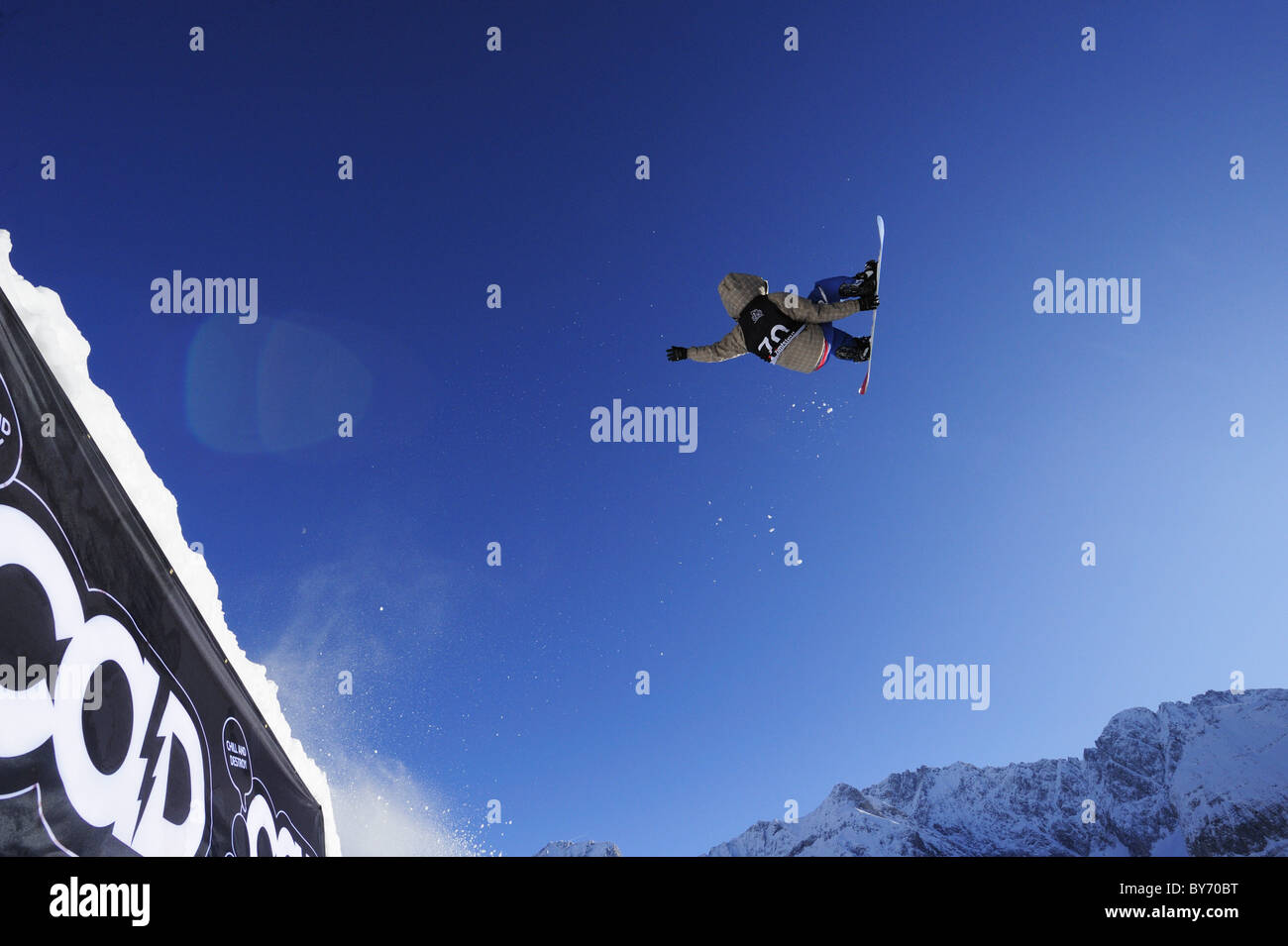 Snowboarder jumping from a kicker, performing a back-flip, funpark Ehrwalder Alm, Tiroler Zugspitzarena, Ehrwald, Tyrol, Austria Stock Photo