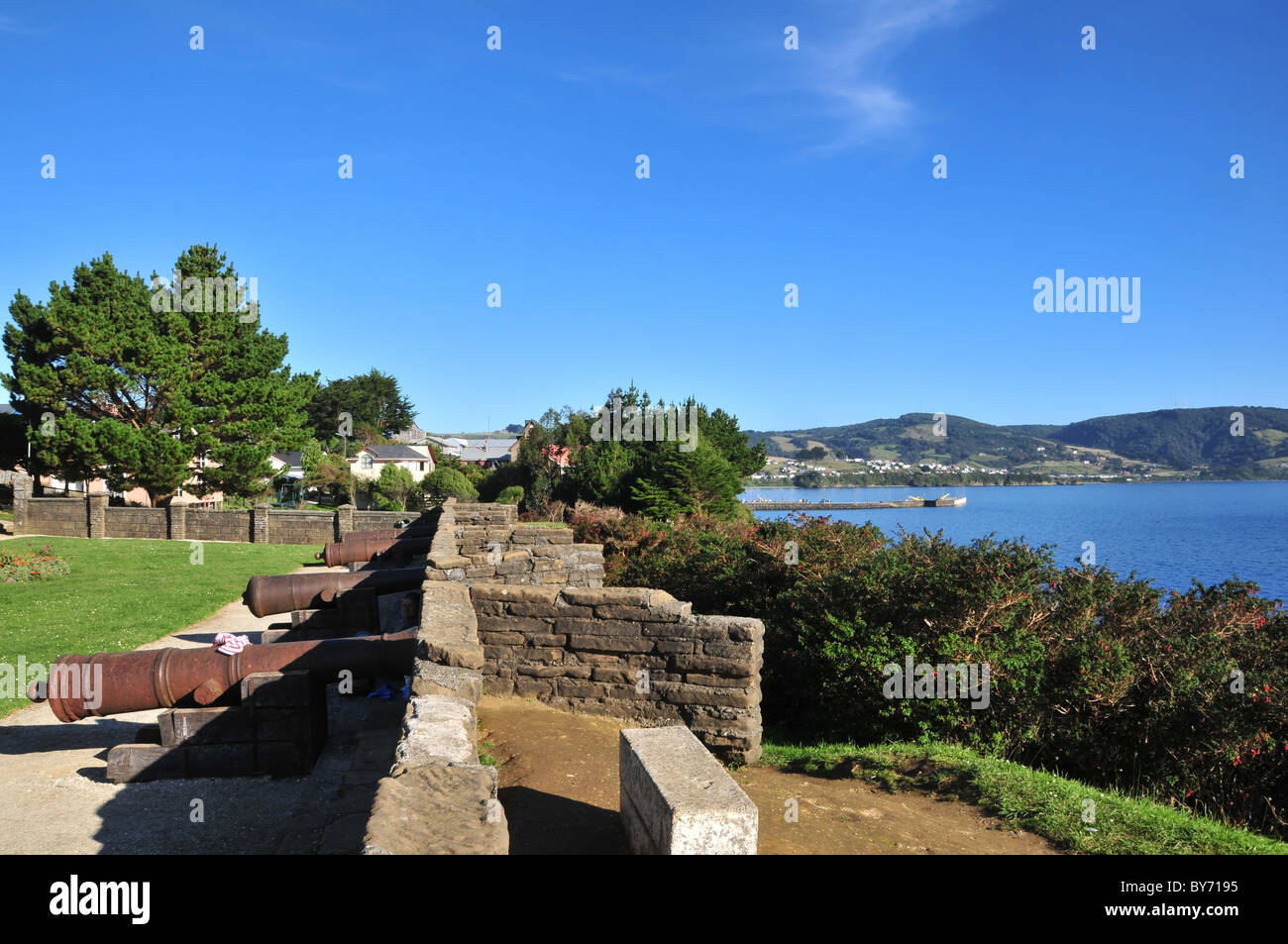 Blue coastal view, looking south, of rusting cannons facing the Gulf of Ancud, Fuerte San Antonio, Ancud, Chiloe Island , Chile Stock Photo