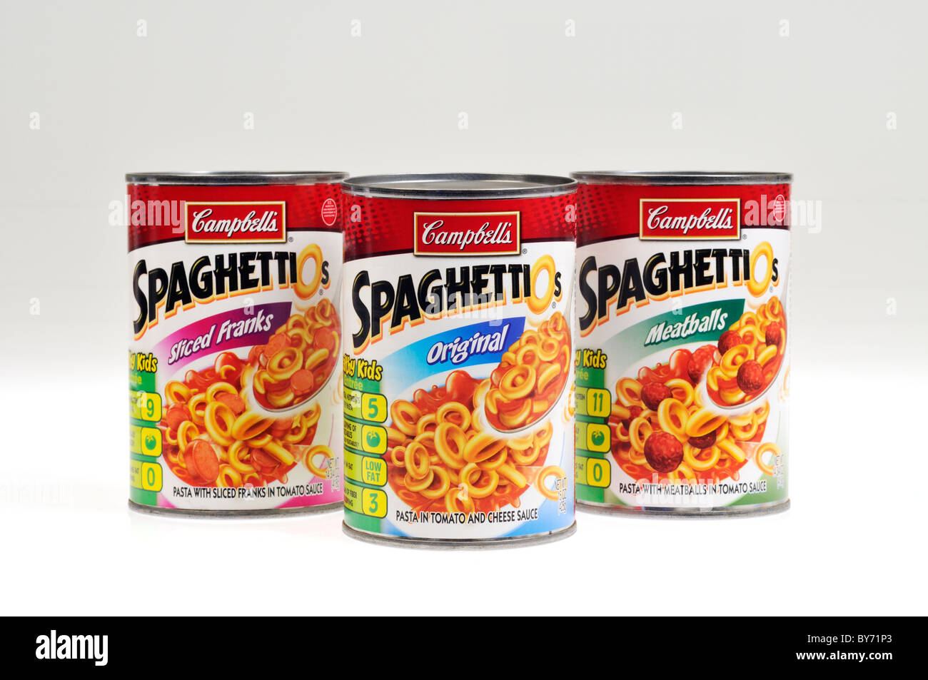 Variety of cans or tins of Campbells Spaghetti-O's with meatballs, sliced franks and original on white background, cut out. Stock Photo