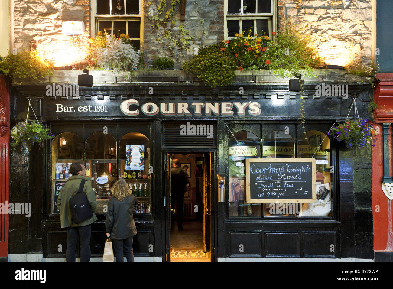 Couple in front of the entrance to the Courtney's Bar, Plunkett Street, Killarney, County Kerry