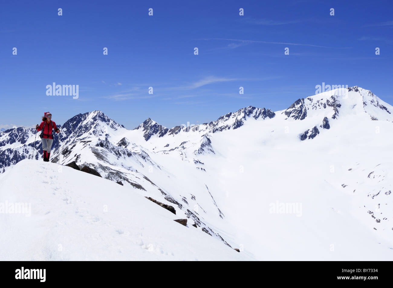 Woman ascending mountain Im Hinteren Eis, Weisskugel in background, Schnals valley, Oetztal Alps, Vinschgau, Trentino-Alto Adige Stock Photo