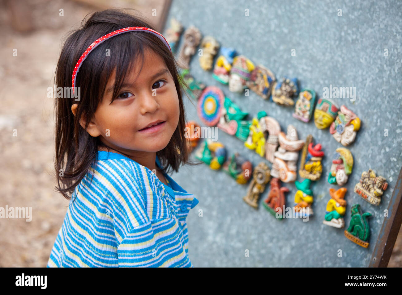 Little mexican girl at her parents souvenir stand, Chichen Itza, Mexico Stock Photo