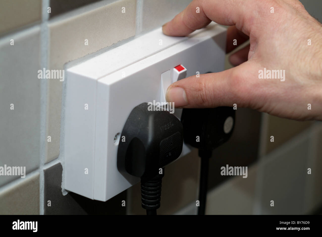 Someone switching on an electrical socket Stock Photo Alamy