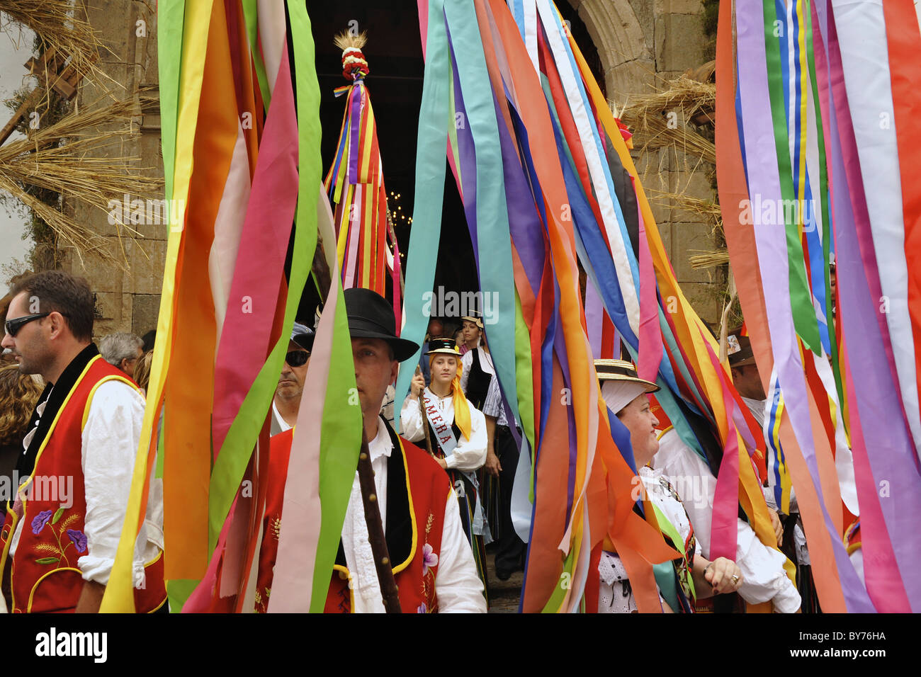Colored ribbons, dancing group of women and man in canrian traditional