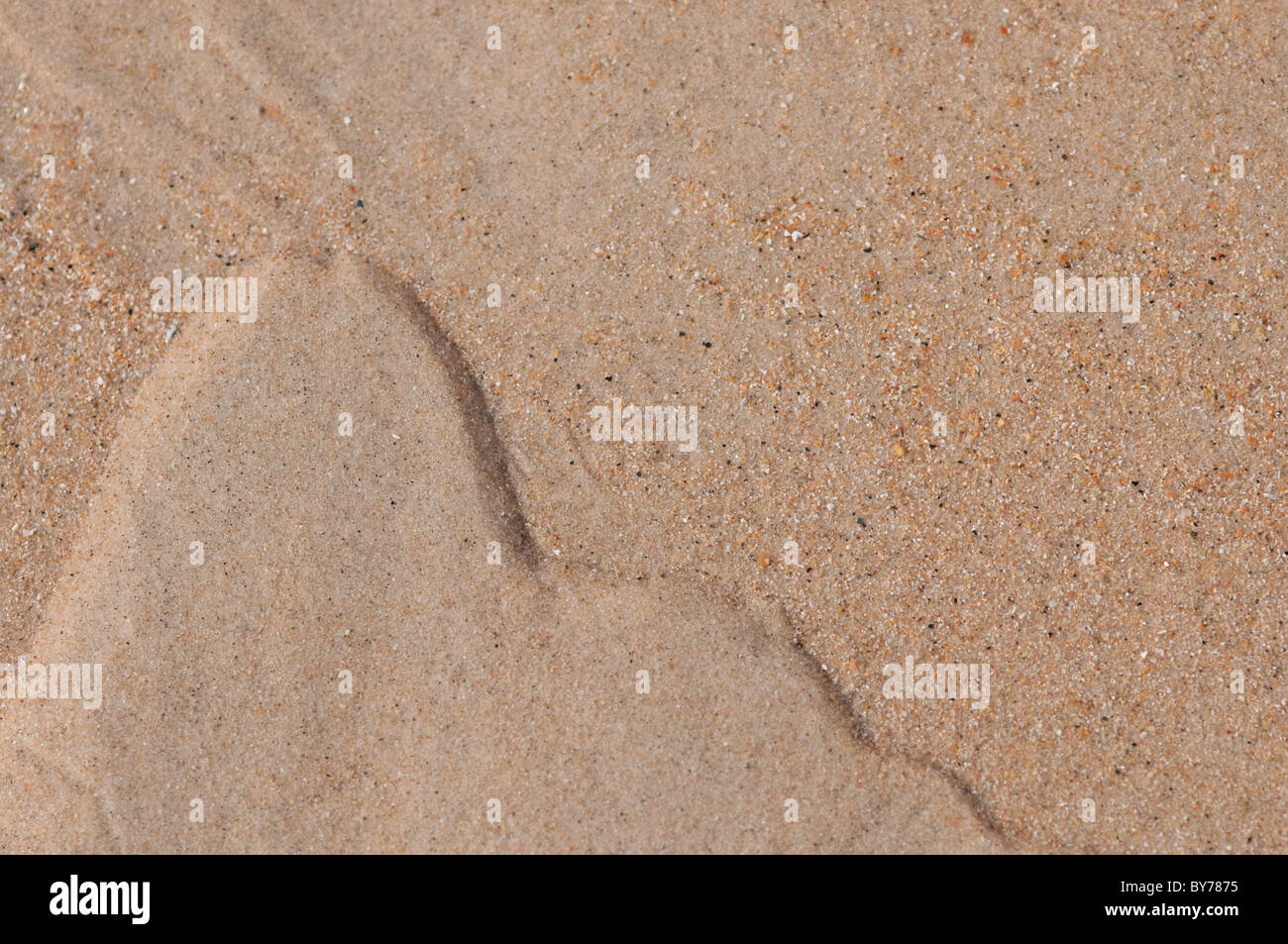Patterns made in the sand by the receeding tide Stock Photo